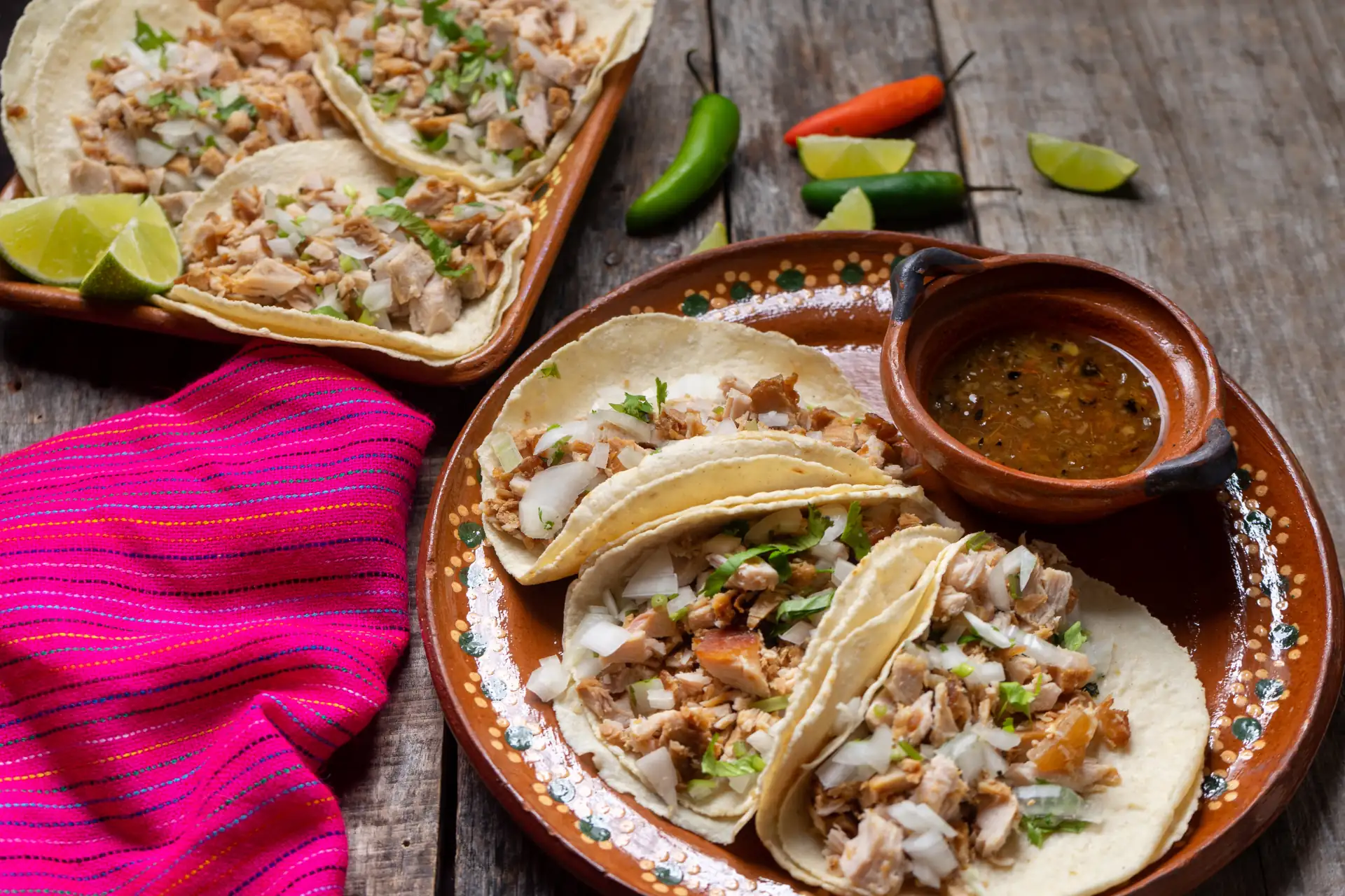 Mexican pork tacos also called carnitas on wooden background