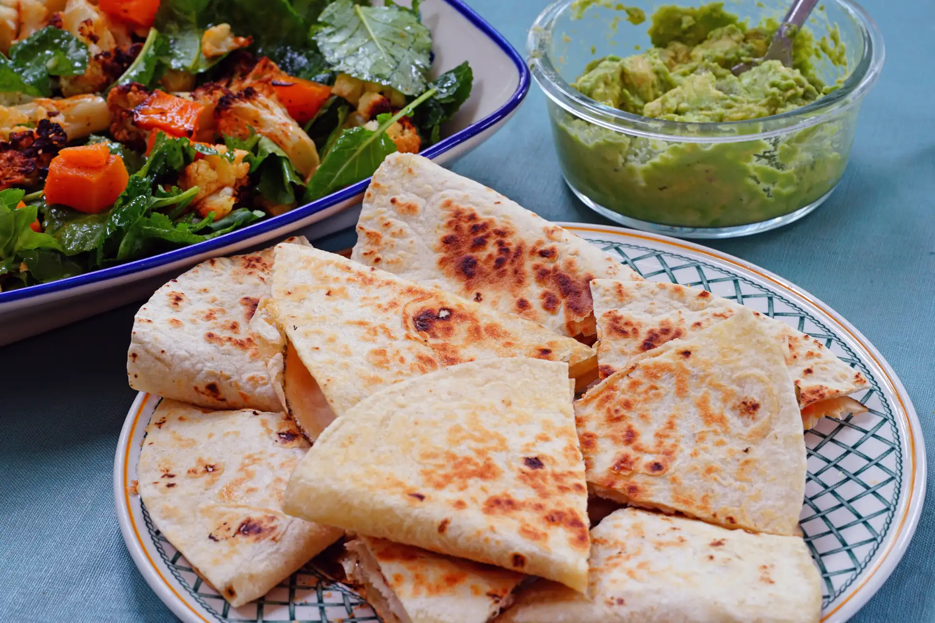 Plate of quesadillas with salad and guacamole